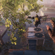A screenshot from the game showing a player jumping across a building while chasing someone.